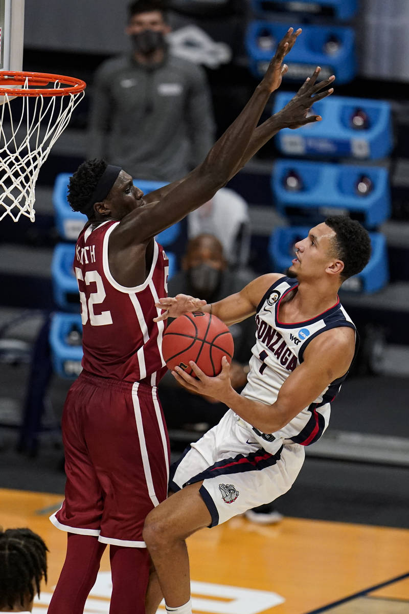 Gonzaga guard Jalen Suggs (1) shoots around Oklahoma forward Kur Kuath (52) in the second half ...