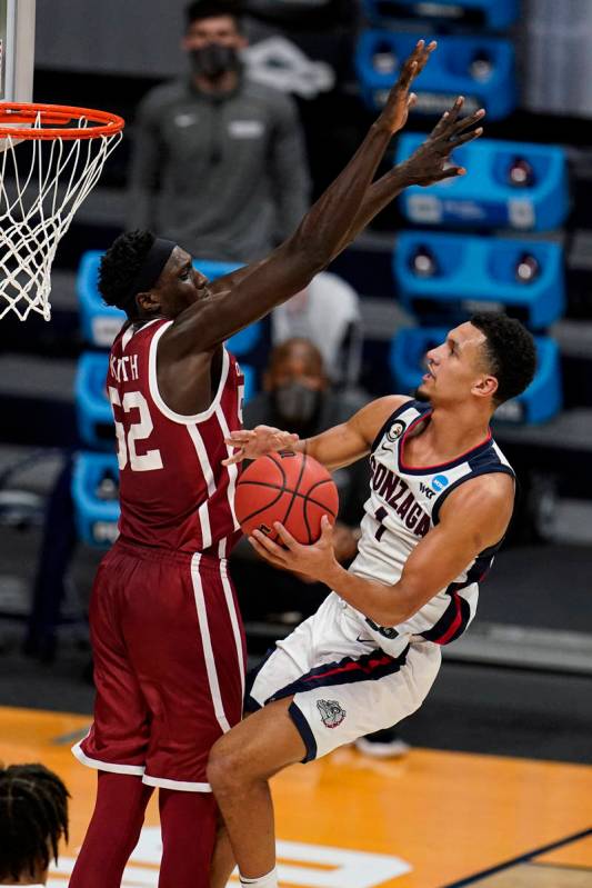 Gonzaga guard Jalen Suggs (1) shoots around Oklahoma forward Kur Kuath (52) in the second half ...