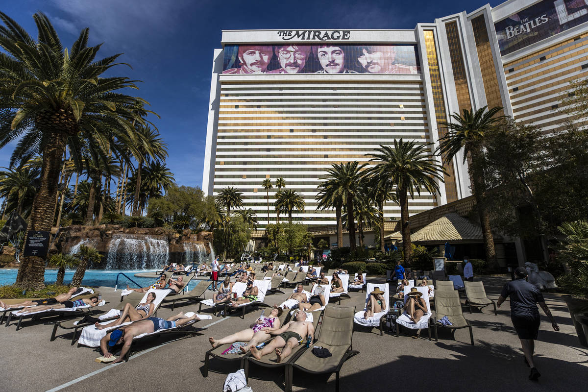 Guests lounge by the pool at The Mirage on Saturday, March 6, 2021, in Las Vegas. (Benjamin Hag ...