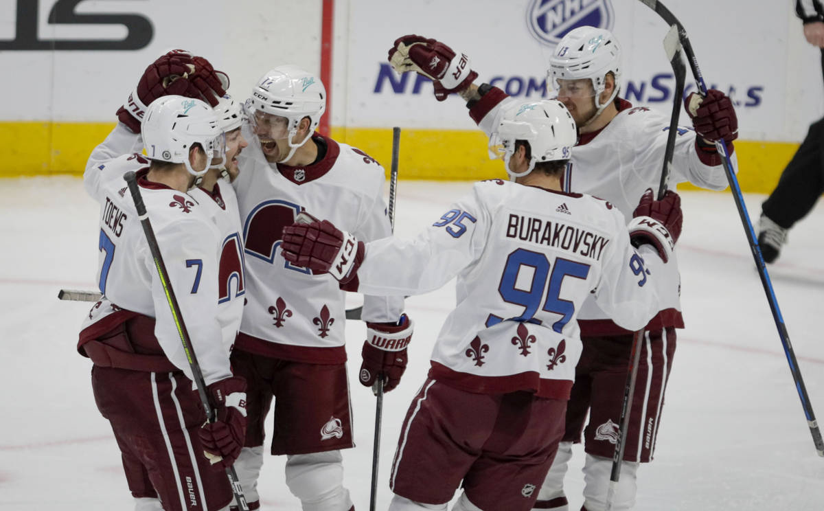 Colorado Avalanche defenseman Devon Toews (7) and Sam Girard, left wing Andre Burakovsky (95) a ...