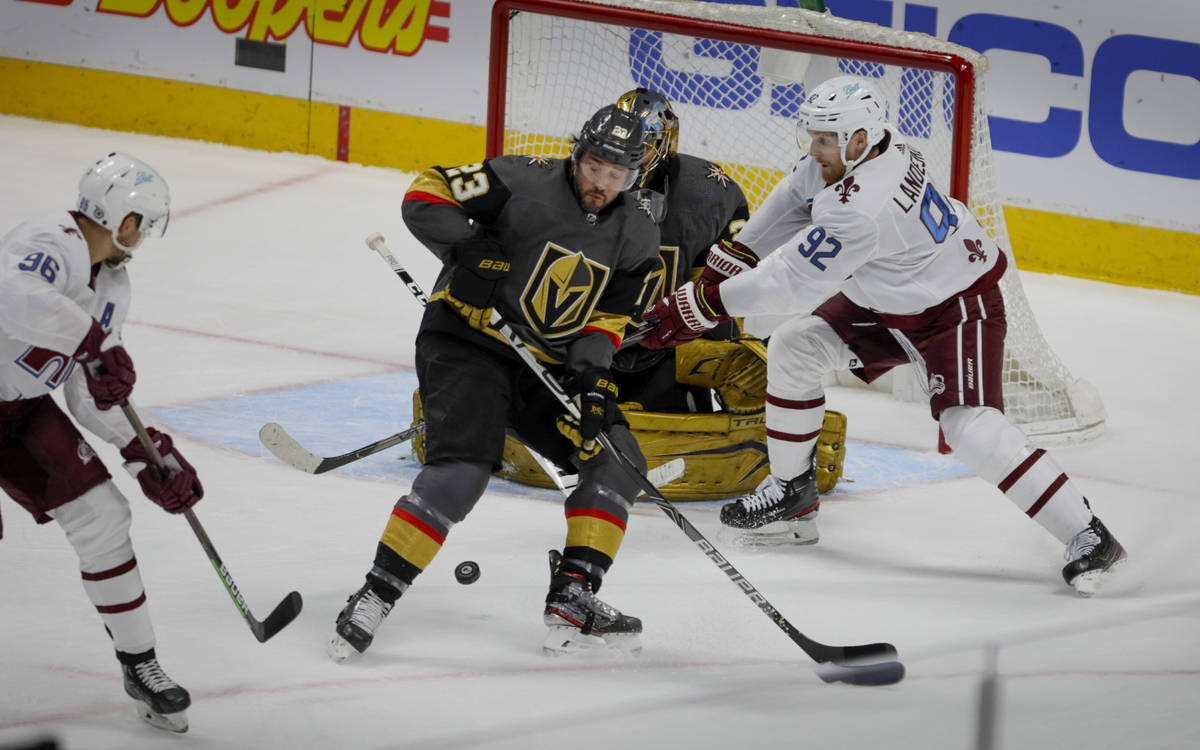 Colorado Avalanche right wing Mikko Rantanen (96) chips the puck past Vegas Golden Knights defe ...