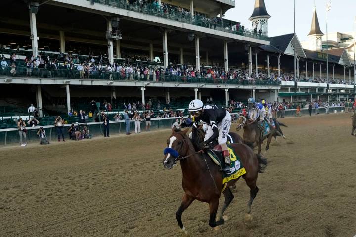 Jockey John Velazquez riding Authentic, wins the 146th running of the Kentucky Derby at Churchi ...