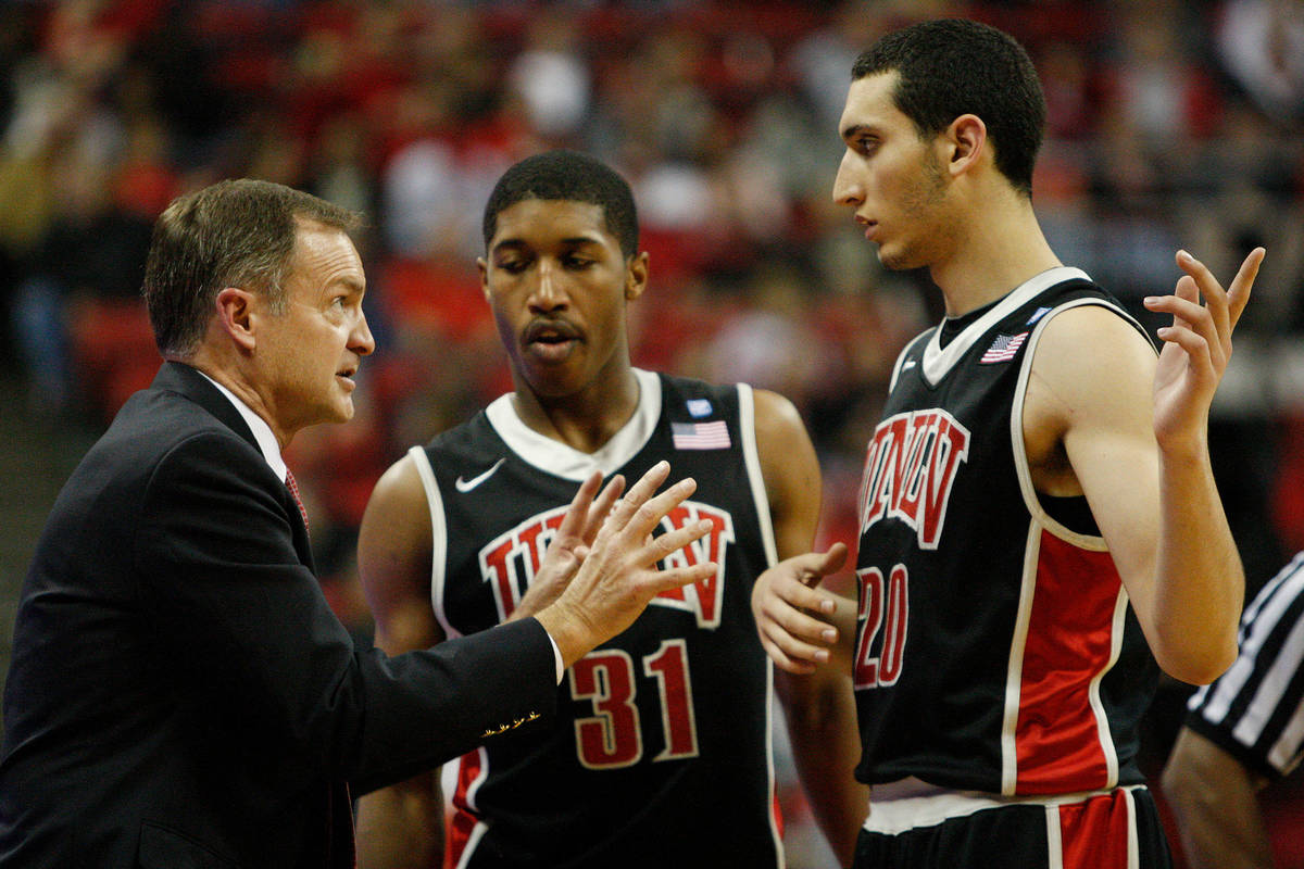 UNLV head coach Lon Kruger, left, speaks with Justin Hawkins and Karam Mashour, right, during t ...