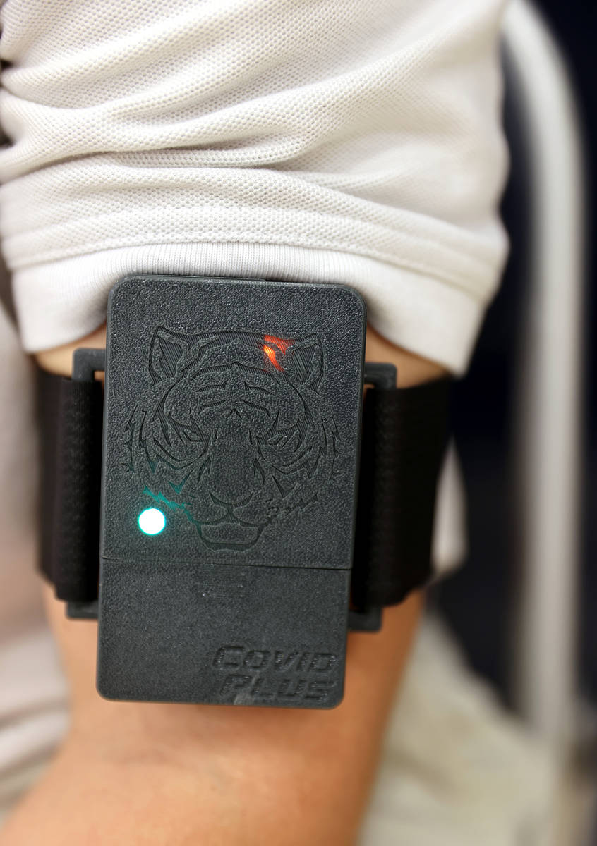 A COVID-19 screening device on students-athlete Logan Weil at The Meadows School in Las Vegas ...
