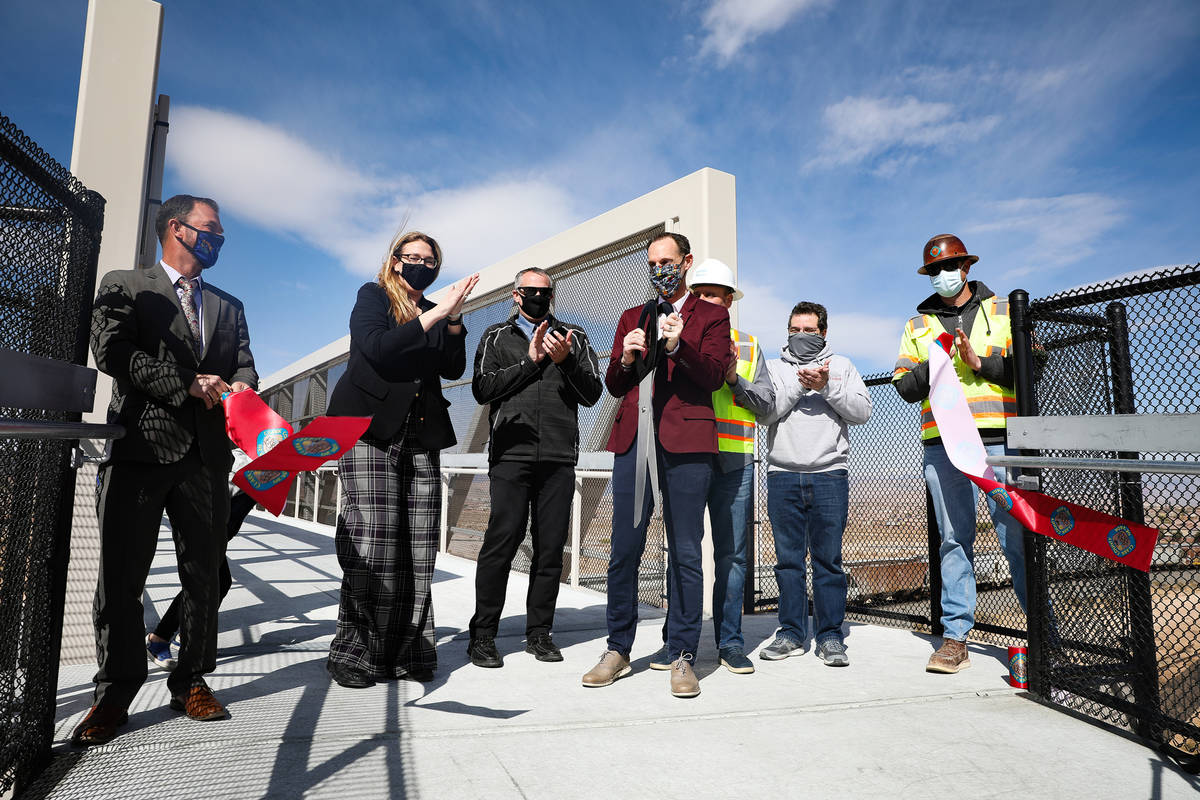 Clark County Commissioner Justin Jones, center, cuts a ribbon surrounded by county employees an ...