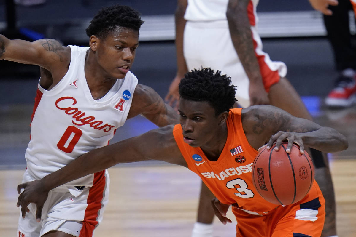 Syracuse forward Kadary Richmond (3) drives on Houston guard Marcus Sasser (0) in the first hal ...