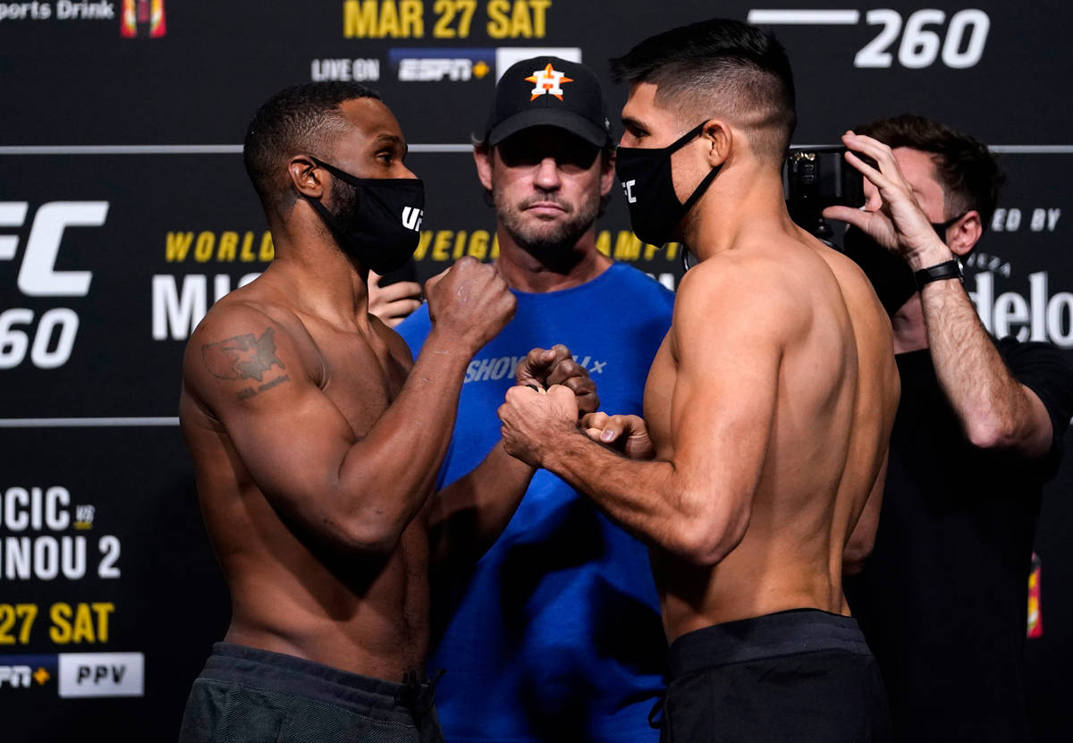 Opponents Tyron Woodley and Vicente Luque face off during the UFC 260 weigh-in at UFC APEX on M ...