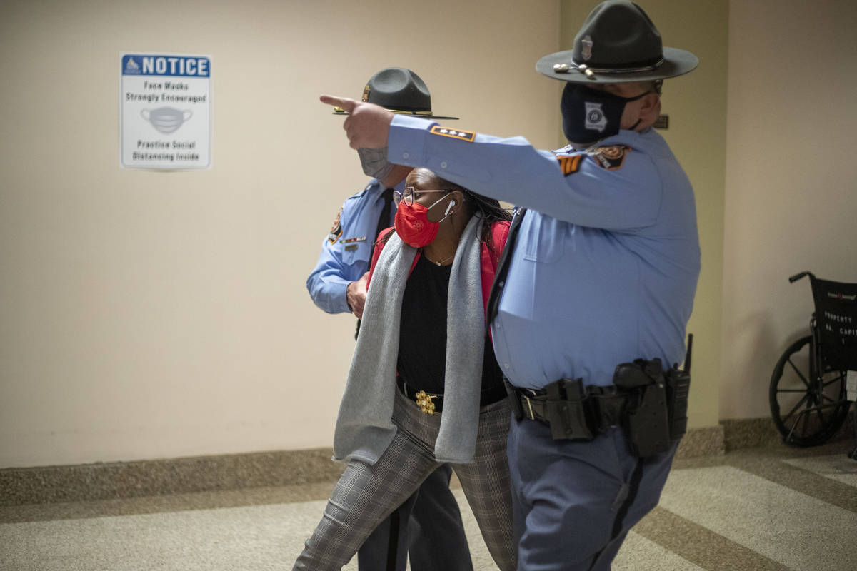 Rep. Park Cannon (D-Atlanta) is escorted out of the Georgia Capitol Building by Georgia State T ...