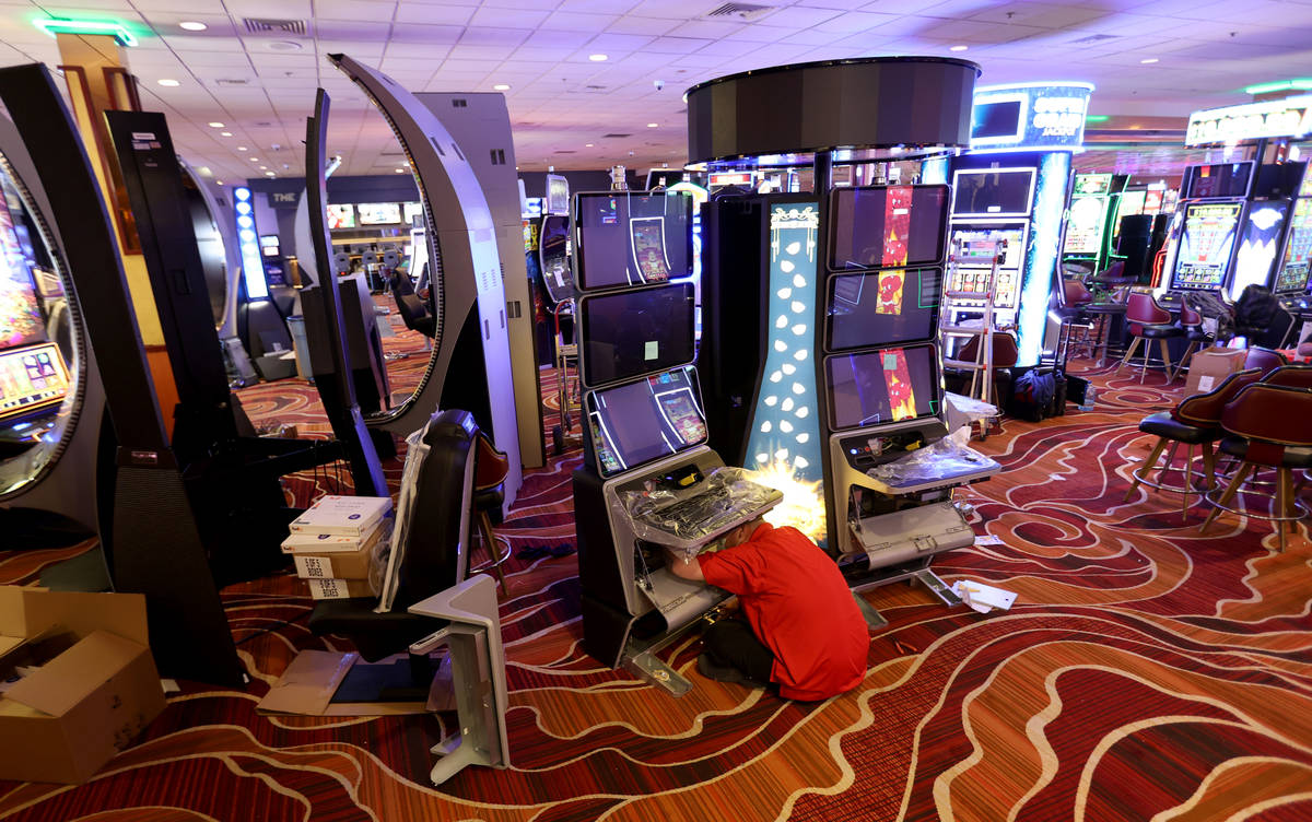 Slot technician David Cameron installs new gaming machines at The Pass on historic Water Street ...