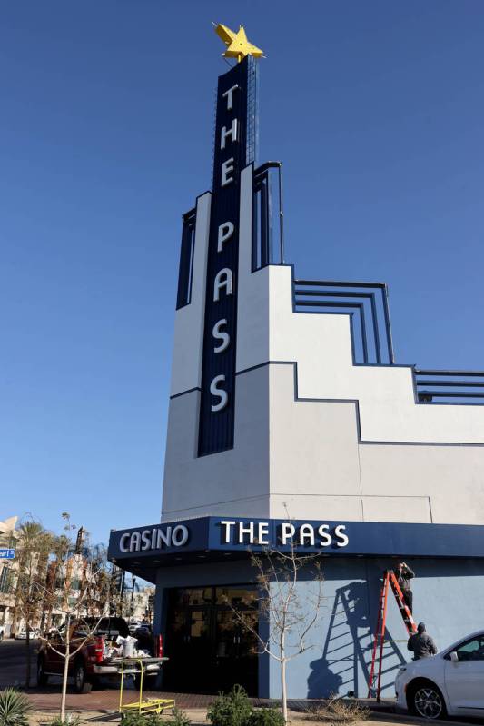 Workers apply the finishing touches at the Water Street entrance to The Pass in downtown Hender ...