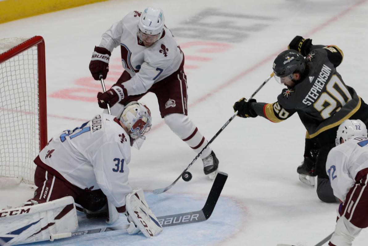 The puck bounces away from Vegas Golden Knights center Chandler Stephenson (20) as Colorado Ava ...