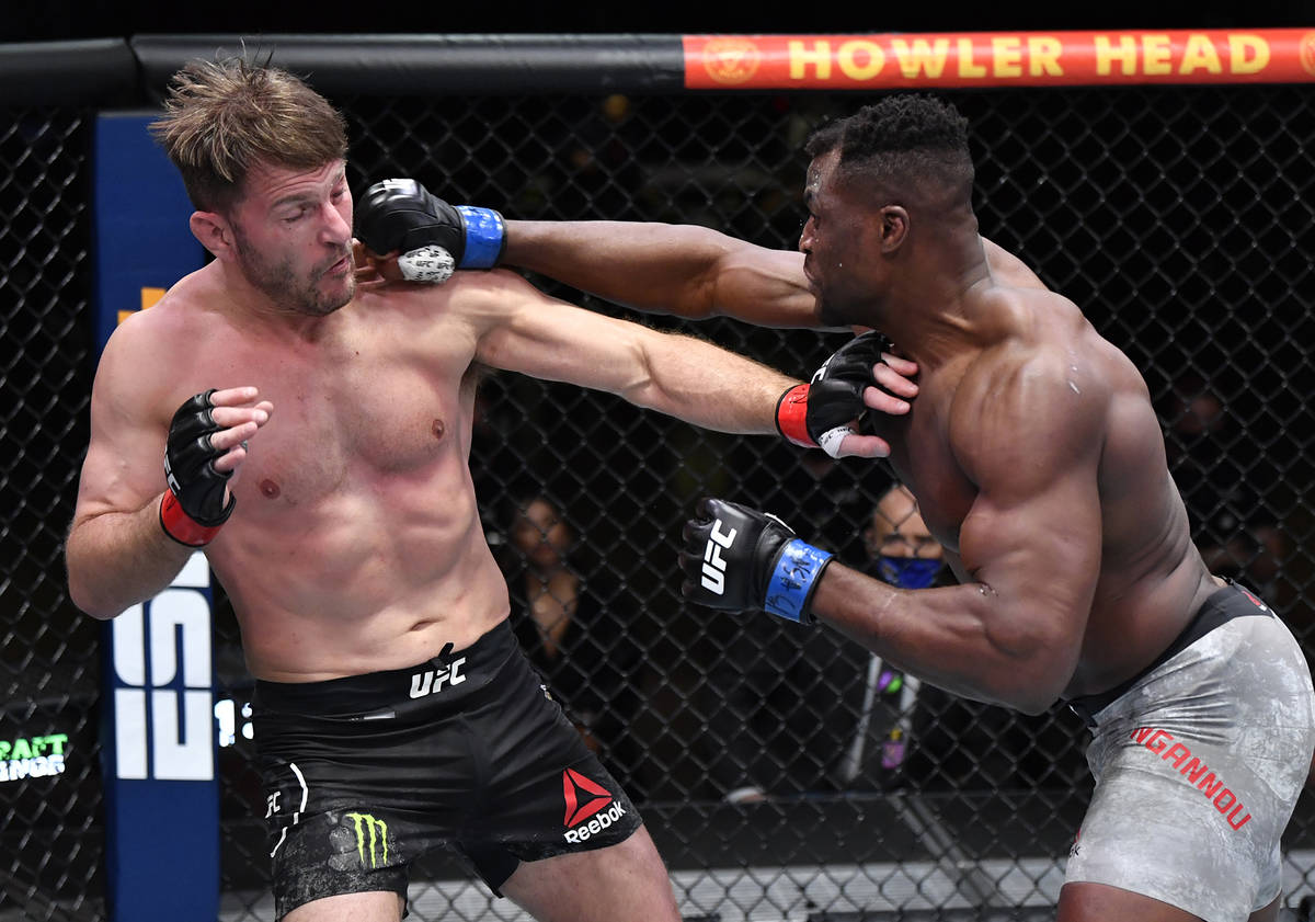 Francis Ngannou of Cameroon punches Stipe Miocic in their UFC heavyweight championship fight du ...
