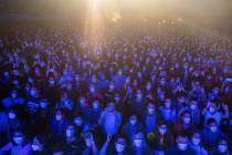 People react ahead of a music concert in Barcelona, Spain, Saturday, March 27, 2021. (AP Photo/ ...