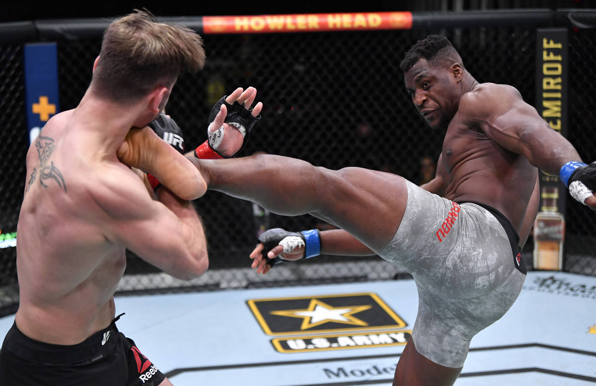 LAS VEGAS, NEVADA - MARCH 27: (R-L) Francis Ngannou of Cameroon kicks Stipe Miocic in their UFC ...