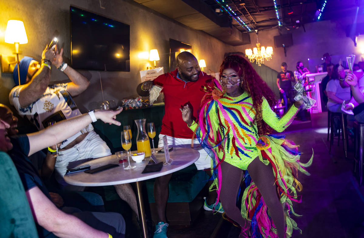 Drag queen Coco Montrese collects tips while performing during the "Bottomless Drag Brunch ...