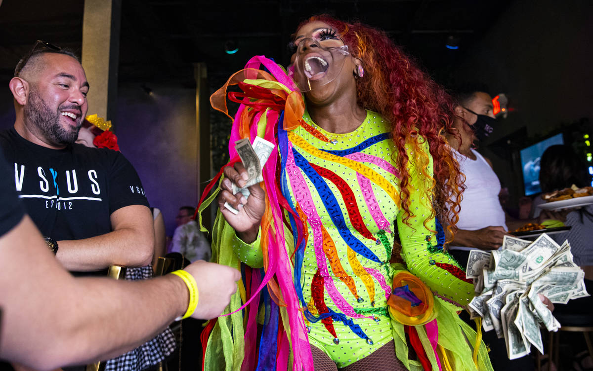Drag queen Coco Montrese collects tips while performing during the "Bottomless Drag Brunch ...