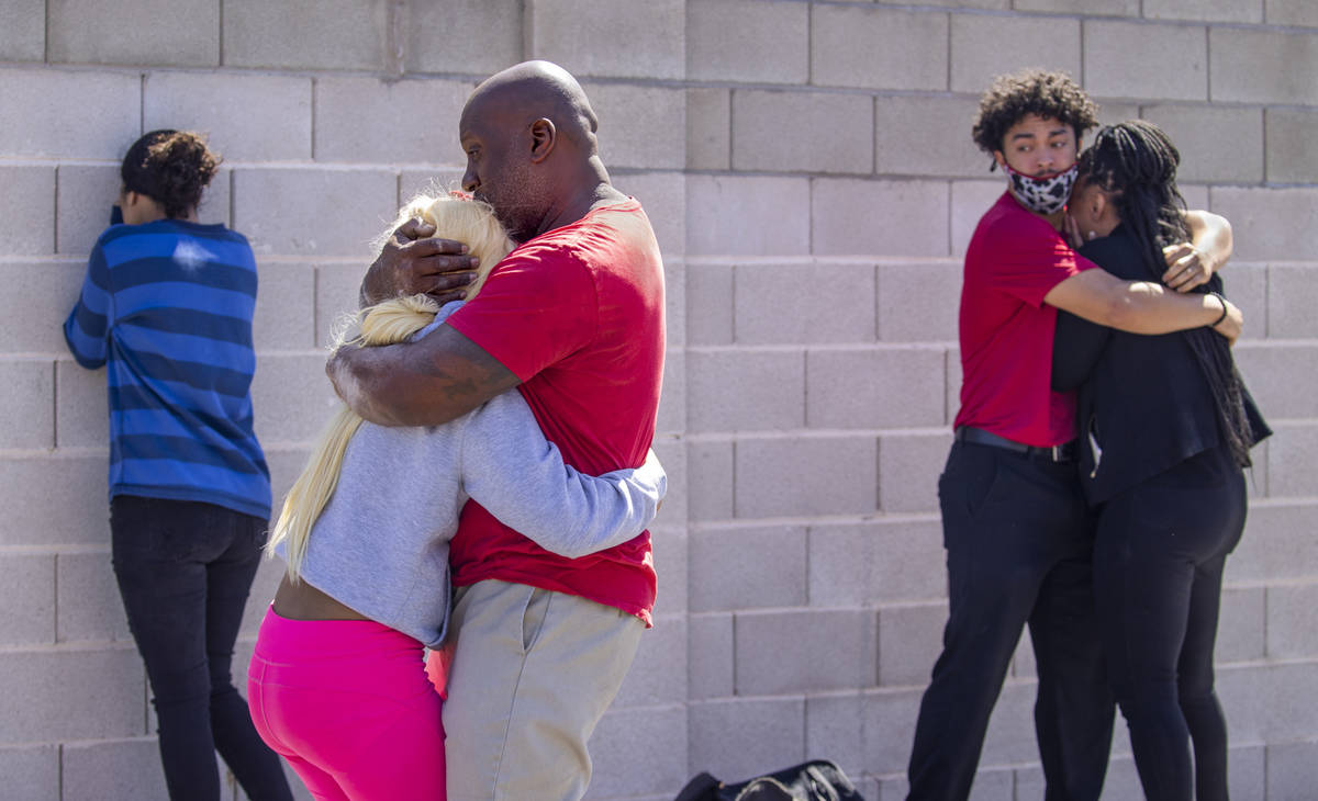 Family members reunite and console each other near where the Clark County Fire Department works ...
