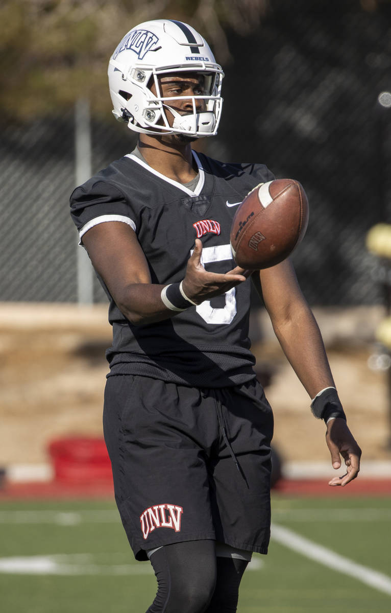 UNLV quarterback Justin Rogers (5) tosses the ball during the first spring football practice at ...