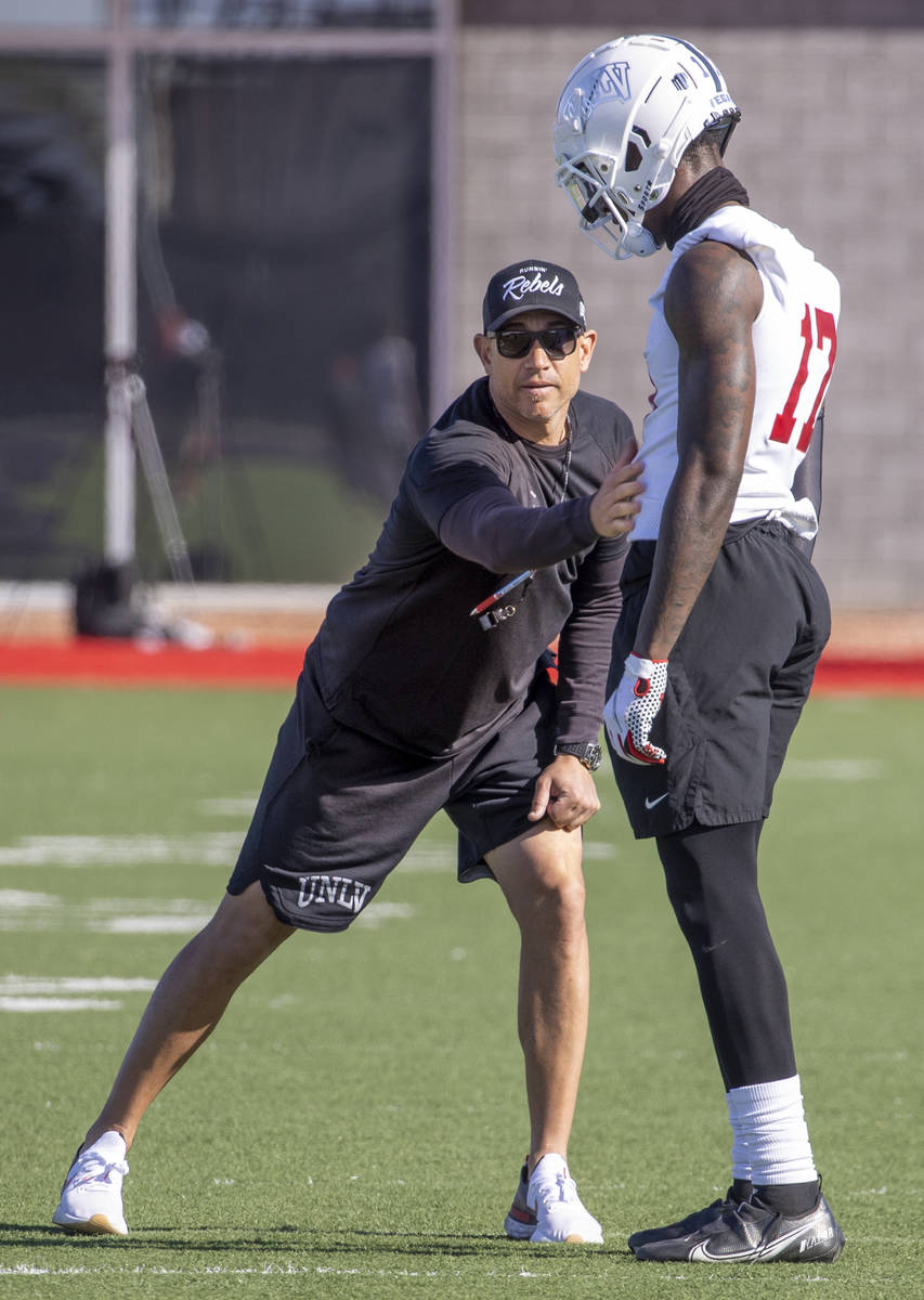 UNLV head coach Marcus Arroyo gives sends wide receiver Jordan Jakes (17) away with a pat after ...