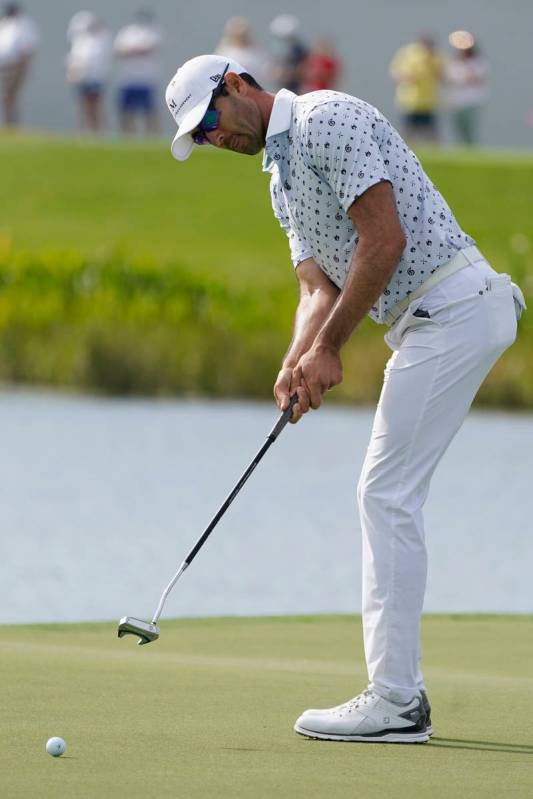 Cameron Tringale putts on the 17th green during the third round of the Honda Classic golf tourn ...