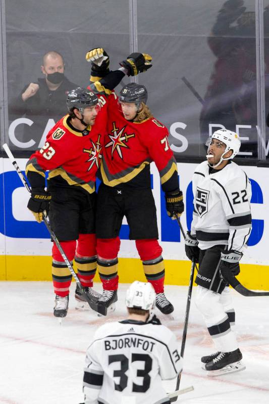 Golden Knights defenseman Alec Martinez (23) and center William Karlsson (71) celebrate a goal ...