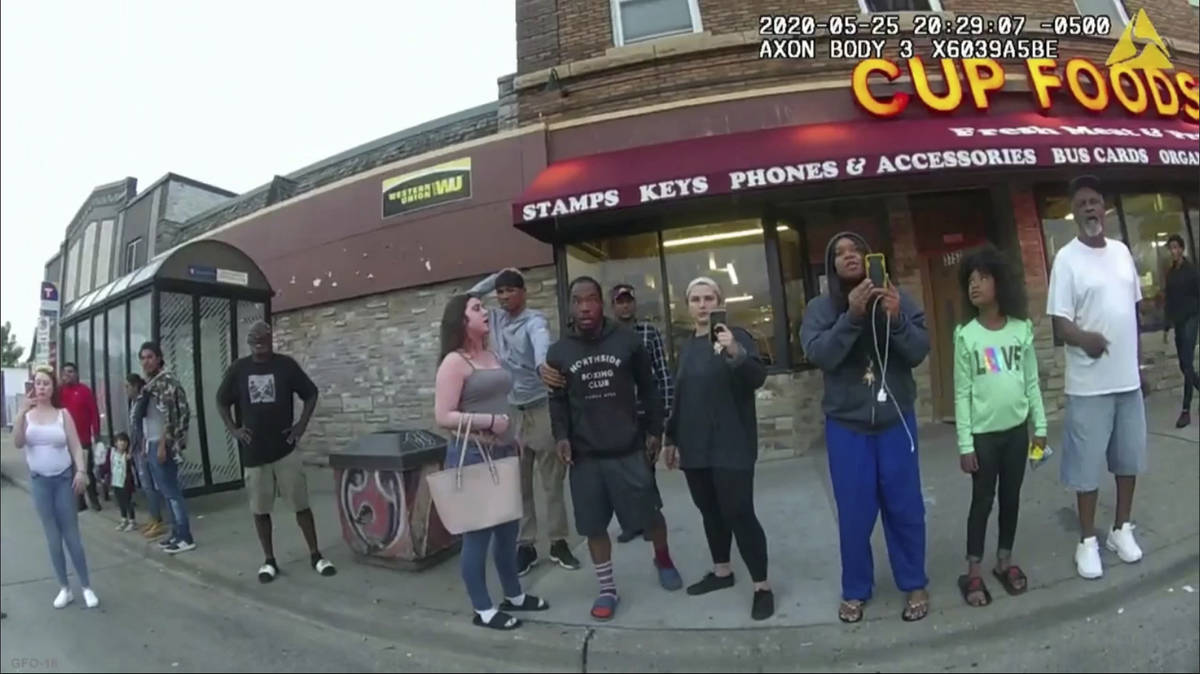 This image from a police body camera shows people gathering as former Minneapolis police office ...