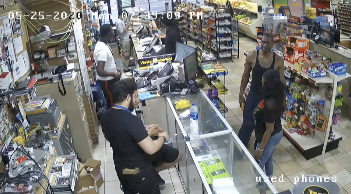 In this image from store video, George Floyd, right, is seen inside Cup Foods on May 25, 2020, ...