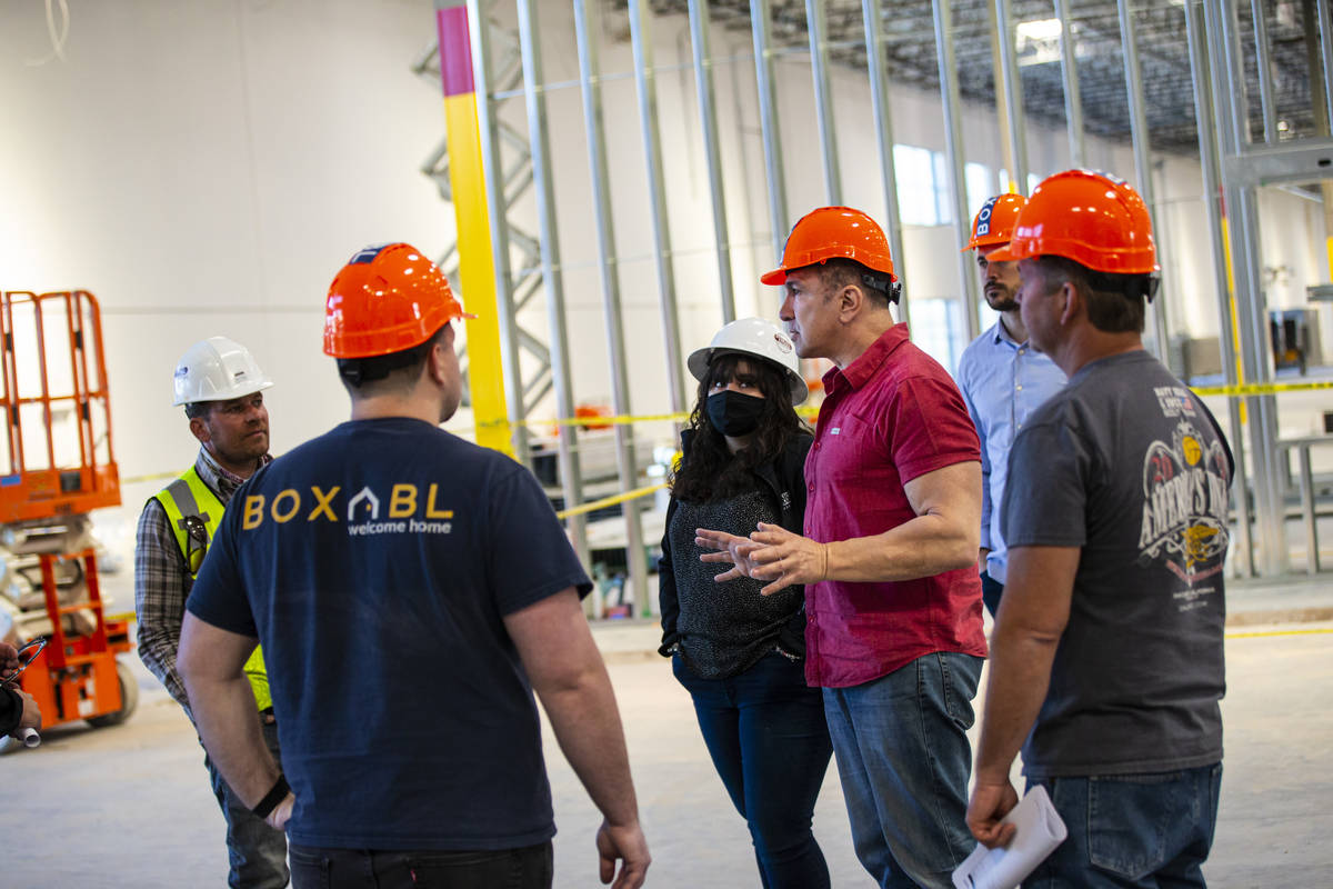 Paolo Tiramani, founder and CEO of Boxabl, fourth from left, talks with team members in their m ...