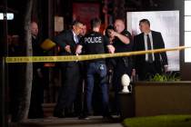 Investigators gather outside an office building where a shooting occurred in Orange, Calif., We ...