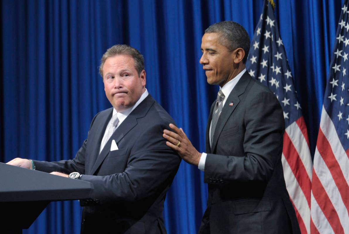 Stephen Cloobeck, left, looks back at President Barack Obama as he is introduced at a fundraise ...