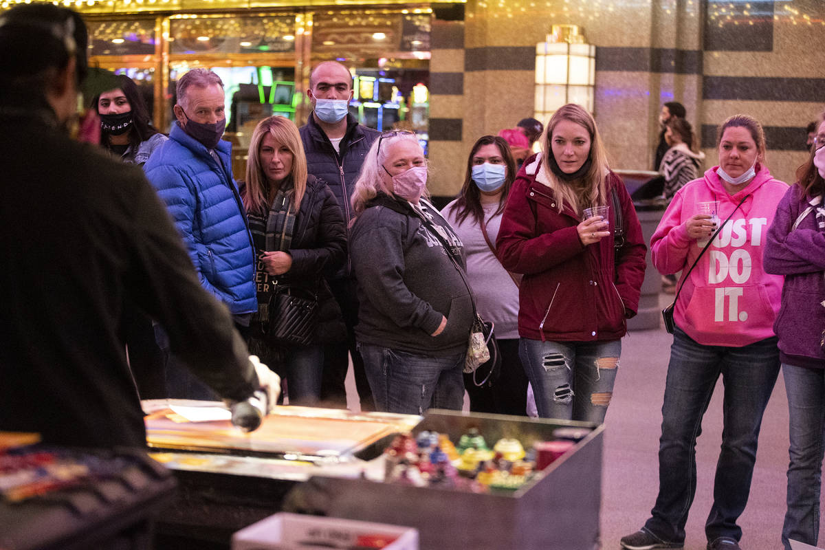 People visit the Fremont Street Experience in Las Vegas, on Friday, March 12, 2021. (Erik Verdu ...