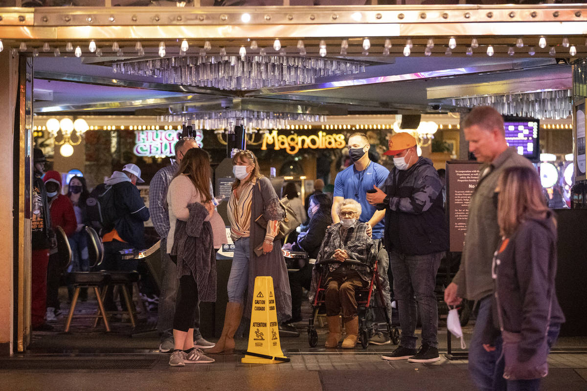 People visit the Fremont Street Experience in Las Vegas, on Friday, March 12, 2021. (Erik Verdu ...