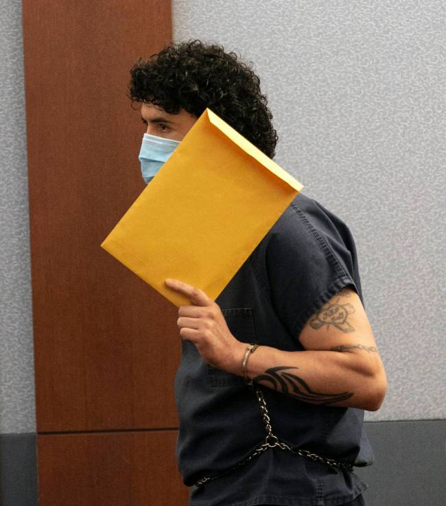 Silvino Hinojosa, a former Topgolf Las Vegas sous chef, hides his face during an October court ...