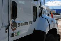 Construction crews with Southwest Gas and ELM Locating and Utility Services work to repair a ga ...