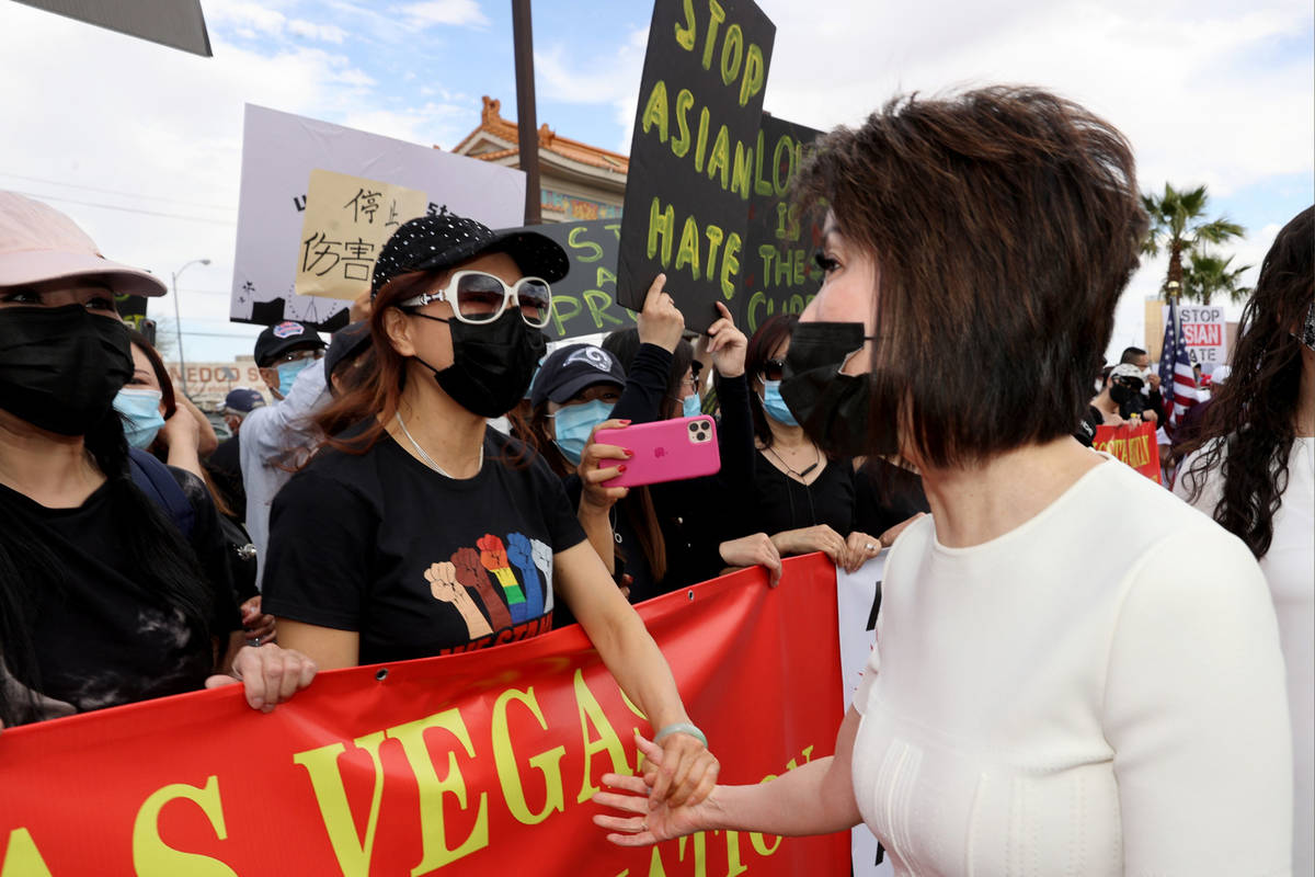 Nevada's first lady Kathy Sisolak greets Suying Chen at a "Stop Asian Hate" event at Chinatown ...