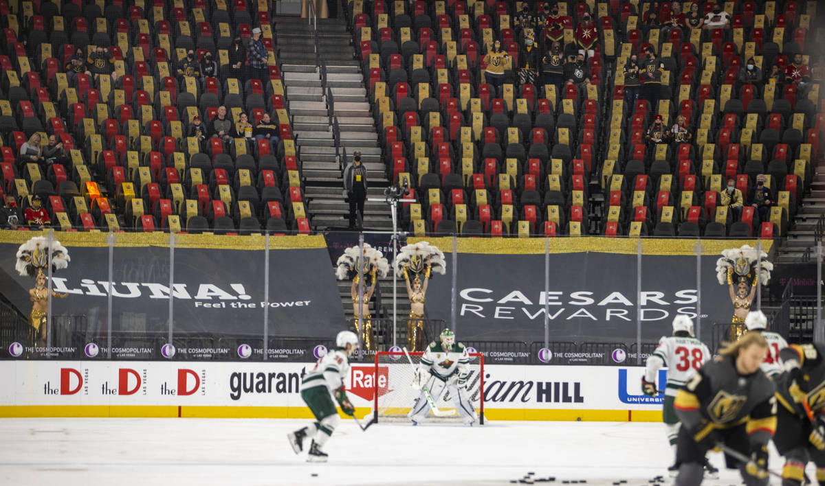 The Vegas Belles dance near the glass as Golden Knights and Minnesota Wild players warm up prio ...