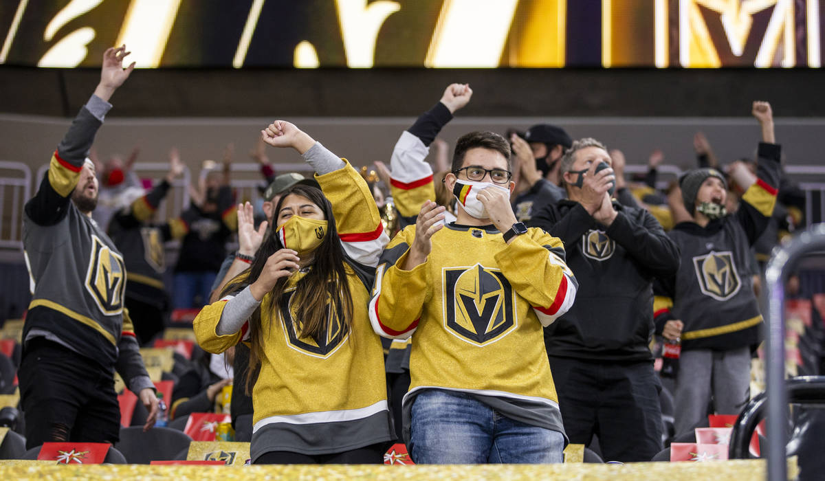 Fans celebrate a goal by Golden Knights center William Karlsson (71) over the Minnesota Wild du ...