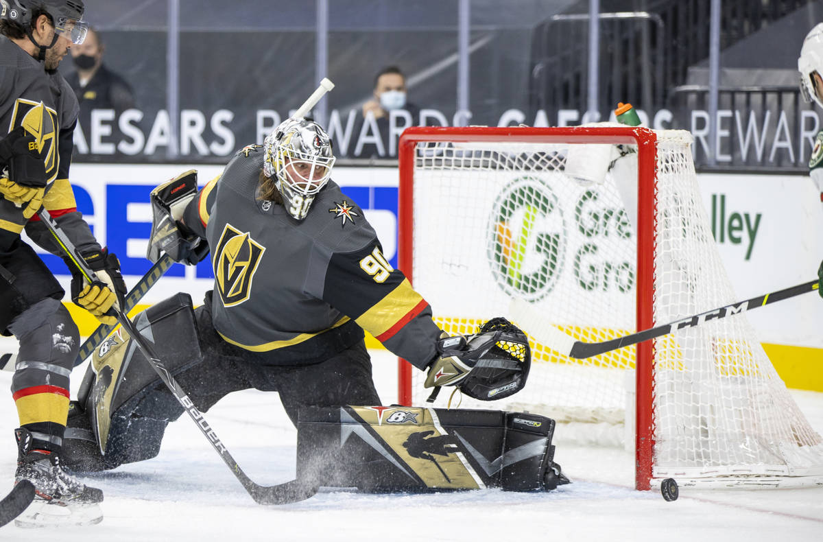 Golden Knights goaltender Robin Lehner (90) deflects a shot on Goa by the Minnesota Wild during ...