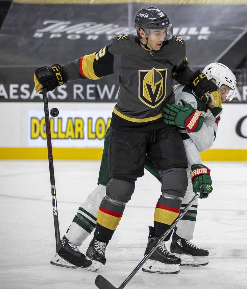 Golden Knights left wing Tomas Nosek (92) battles for the puck with Minnesota Wild defenseman I ...