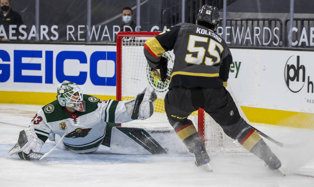 Minnesota Wild goaltender Cam Talbot (33) makes a diving catch as Golden Knights right wing Kee ...