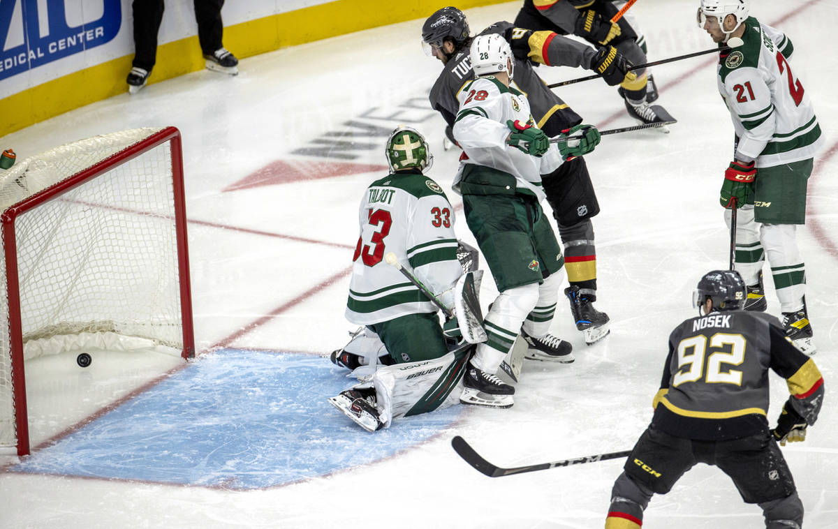 Golden Knights right wing Alex Tuch (89) looks as the puck rolls past Minnesota Wild goaltender ...