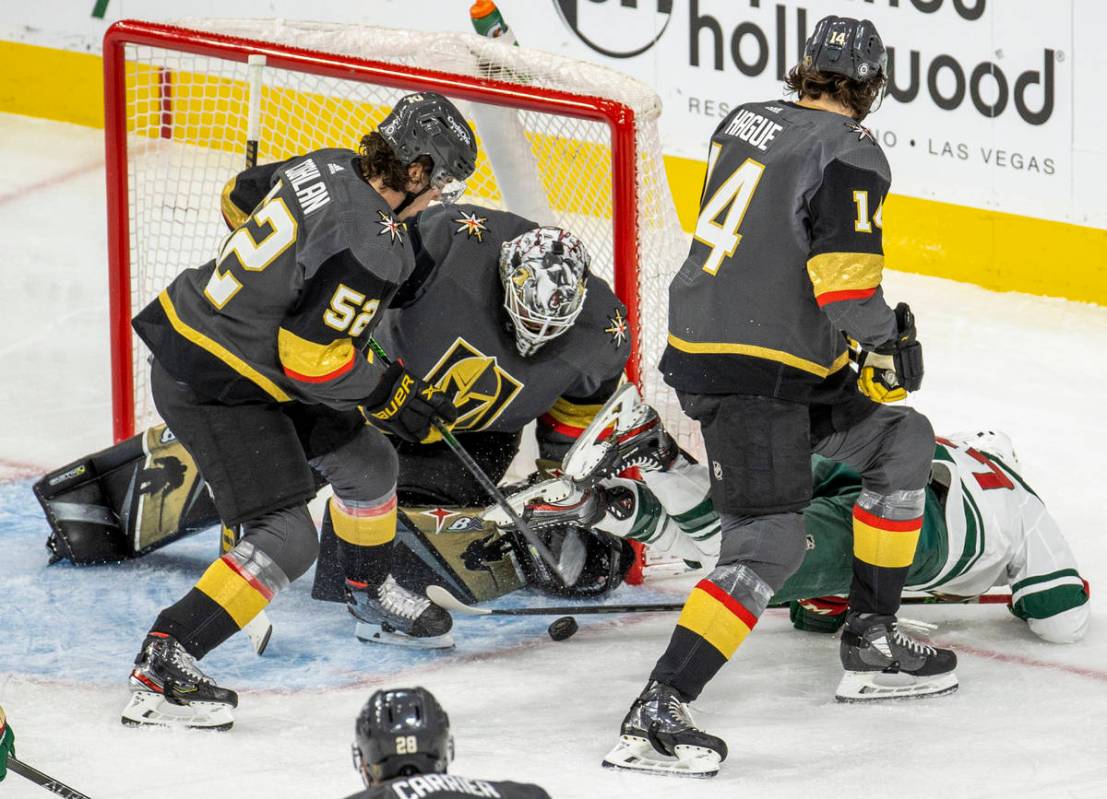 Golden Knights goaltender Robin Lehner (90), defenseman Dylan Coghlan (52) and defenseman Nicol ...