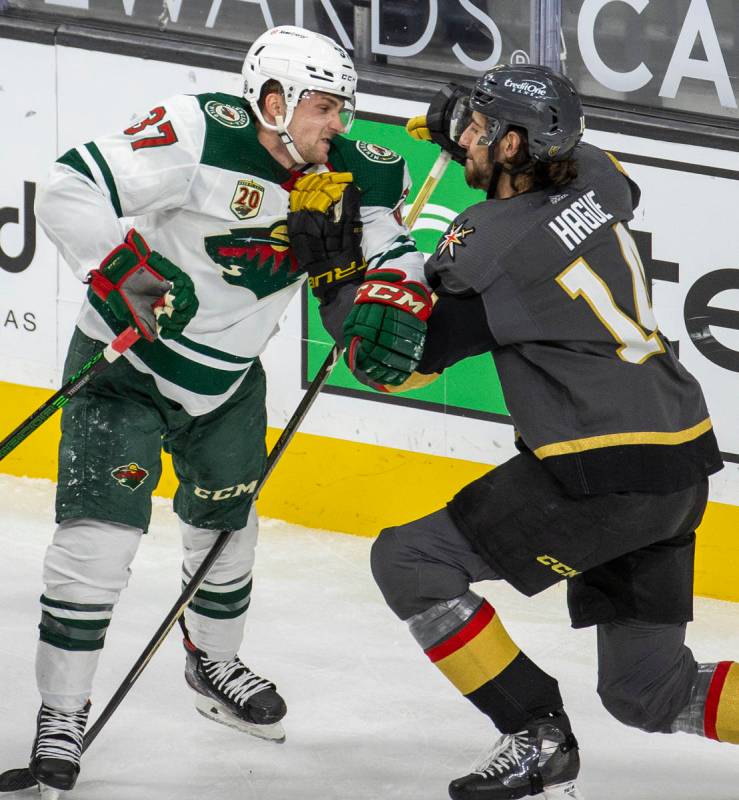 Minnesota Wild center Kyle Rau (37) takes a shot to the chin from Golden Knights defenseman Nic ...