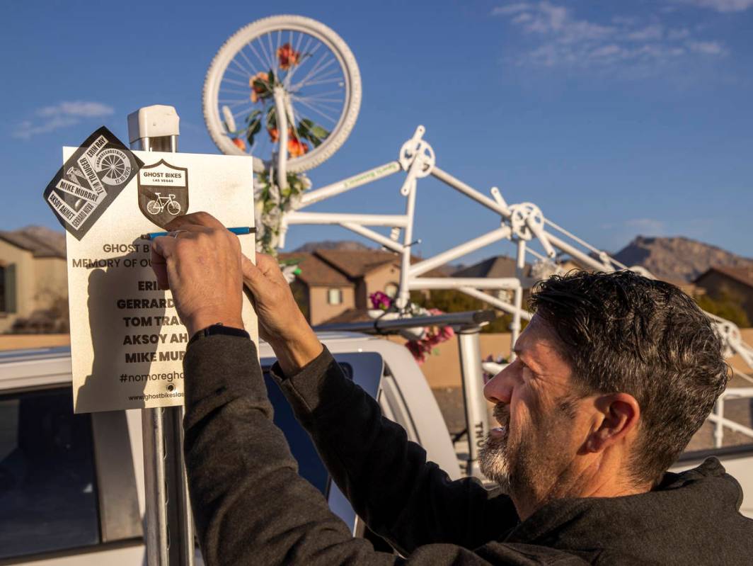 Pat Treichel with Ghost Bikes Las Vegas removes a plaque as they relocate their 5-person bike f ...
