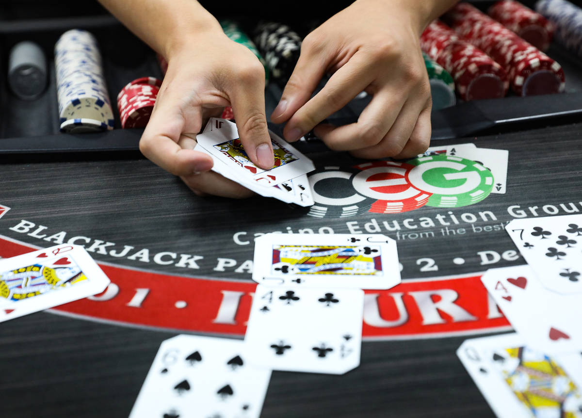 Marvin Ly practices dealing blackjack at the CEG Dealer School in Las Vegas, Thursday, April 1, ...