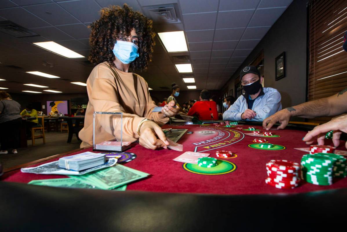 Instructor Yodit Girma, left, deals cards while working a blackjack table with students, includ ...