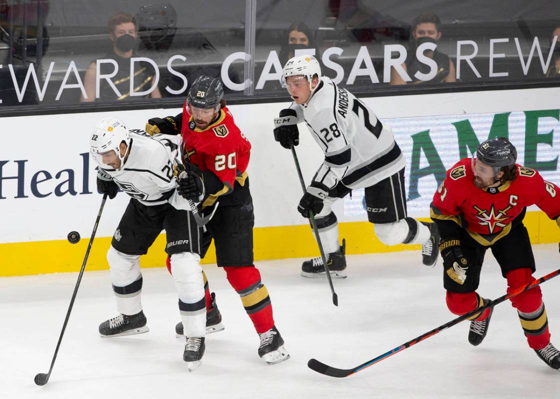 Kings left wing Andreas Athanasiou (22) and Golden Knights center Chandler Stephenson (20) eye ...