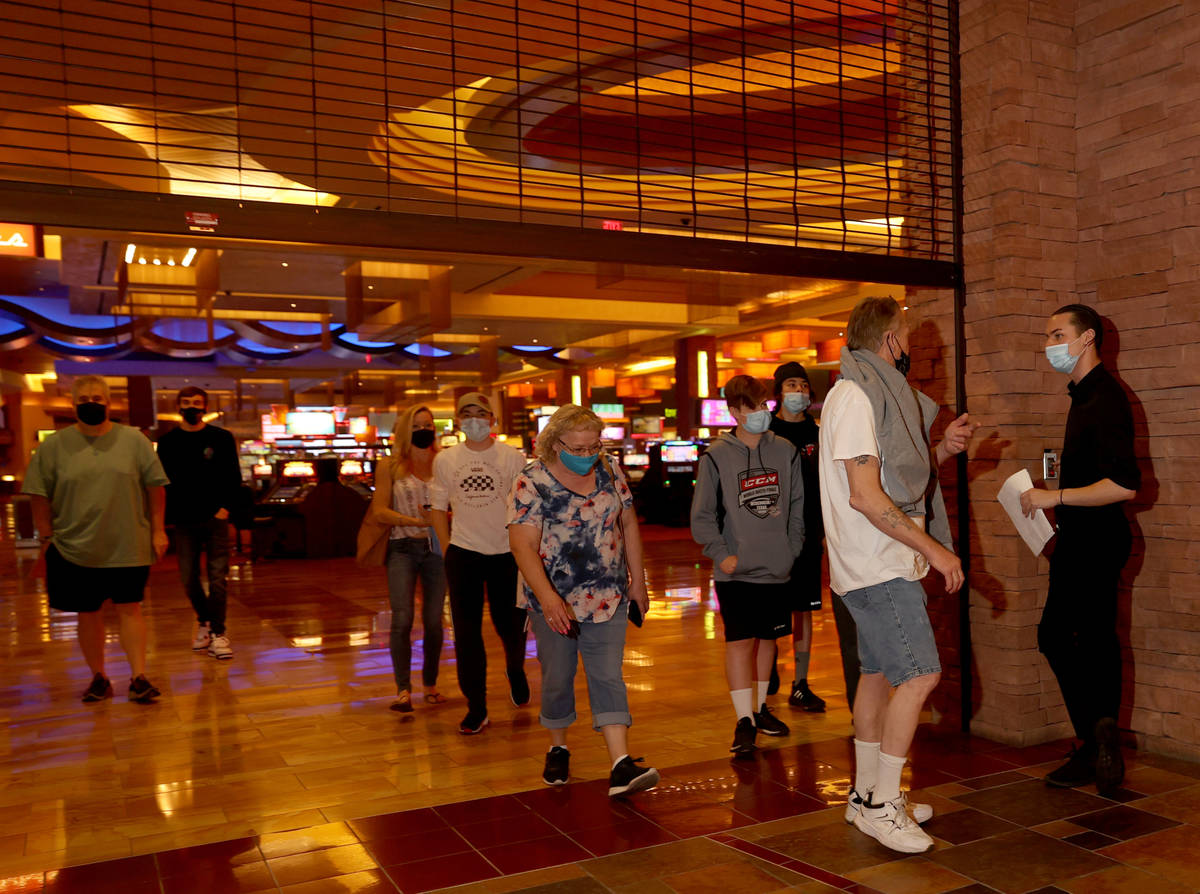People file in as the gate raises at Regal theaters at Red Rock Resort in Las Vegas on reopenin ...