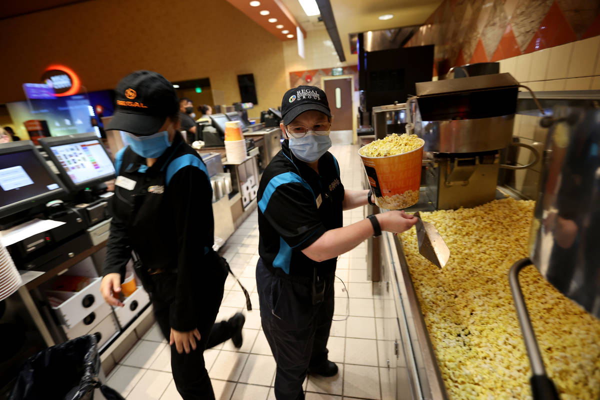 Beth Pollock, right, and Megan Ortega rush to fill concession orders at Regal theaters at Red R ...