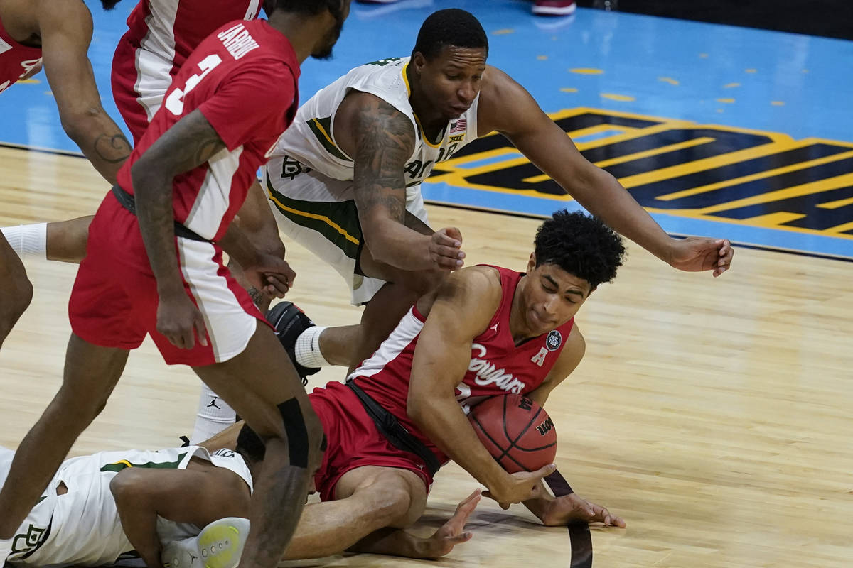 Baylor guard Mark Vital, top, fights for a loose ball with Houston guard Quentin Grimes, right, ...
